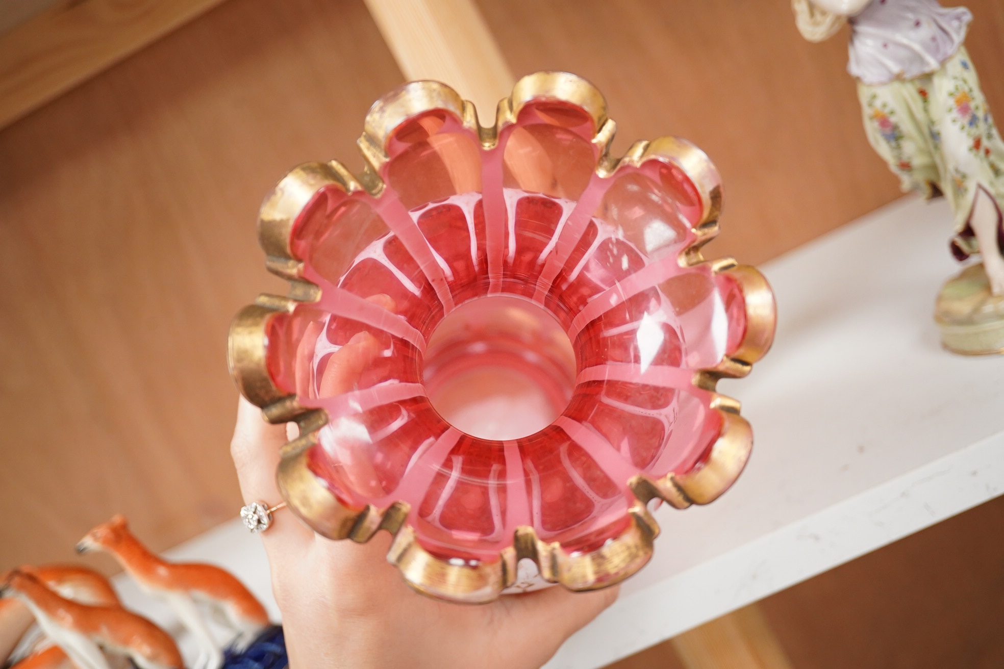 A 19th century Bohemian overlaid and gilt decorated cranberry glass vase, 29cm high. Condition - gilt decoration worn in places